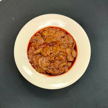 Ethiopian-style mushroom stew made with sautéed mushrooms, onions, garlic, tomatoes, and traditional spices, served on injera.